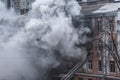 Odessa, Ukraine - Dec. 29, 2016: A fire in an apartment building. Strong bright light and clubs, smoke clouds window of their