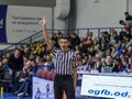 Odessa, Ukraine - February 16, 2019: A sports basketball referee oversees the battle of basketball players on the court during a Royalty Free Stock Photo