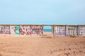 Odessa, Ukraine - 04 20 21: a hole in fence with graffiti as an entrance to Fishing Port beach in Sauvignon district