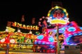 Odessa Ukraine July 2021: illumination working theme park. Spinning carousel. Fast moving illuminated ferris wheel Royalty Free Stock Photo