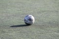 ODESSA, UKRAINE - JULY 2019: Old shabby soccer ball on a sports soccer field. Ukrainian children`s football tournament