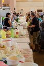 Odessa, Ukraine - July 18, 2019. Privoz market. Buyers taste and choose organic farm dairy products. Indoor Royalty Free Stock Photo