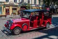 Odessa, Ukraine. July 22.2021. Red tourist retro car on the street of the old city, sightseeing tour