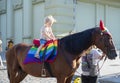 Odessa, Ukraine. July 22th 2018. Horse decked in pride colors. Horse riding - little girl is riding a horse