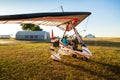 Odessa, Ukraine - July 14, 2016: Young girl with pilot preparing to start the flight at motor hang glider.