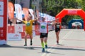 Excited male runner crossing the finshline of a marathon Royalty Free Stock Photo
