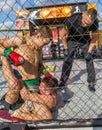 ODESSA, UKRAINE-June 30, 2019: Fighters of MMA boxers are fighting without rules in cage ring of octagons. MMA fighters in ring at