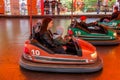 Odessa, Ukraine - June 13, 2016: A group of happy parents, boys and girls having fun and joy ride in bumper car on fairground Royalty Free Stock Photo