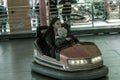 Odessa, Ukraine - June 13, 2016: A group of happy parents, boys and girls having fun and joy ride in bumper car on fairground Royalty Free Stock Photo