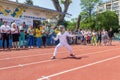 Odessa, Ukraine - June 9, 2020: Young female athlete wearing a mask and white fencing costume on the track of stadium during a