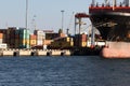 Odessa, Ukraine-202: Logistics terminal sends import-export cargo containers to cargo ship in seaport. Industrial landscape with