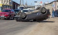 ODESSA, UKRAINE March 19, 2019: after car accident, broken car rolled over and lay down on roof on road that other cars drive.