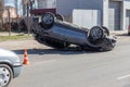 ODESSA, UKRAINE March 19, 2019: after car accident, broken car rolled over and lay down on roof on road that other cars drive.