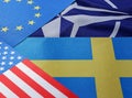 Odessa, Ukraine, March 02, 2023 Flag of Sweden, USA, EU against the background of the NATO symbol