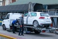 Odessa, Ukraine - March 11th 2020: Loading broken white car on tow truck. Damage vehicle after crash accident. Roadside Royalty Free Stock Photo