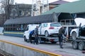 Odessa, Ukraine - March 11th 2020: Tow truck picking up and towing old broken down car on tow truck. Damage vehicle Royalty Free Stock Photo