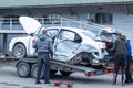 Odessa, Ukraine - March 11th 2020: Tow truck loads white smashed car after traffic accident