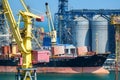 Odessa, Ukraine, May 4, 2019 - industrial seaport infrastructure, sea, cranes and dry cargo ship, grain silo, bulk carrier vessel