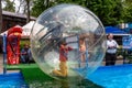 Odessa, Ukraine - May 6, 2019. Little children in an inflatable balloon, having fun on the water. The ball in the water - Royalty Free Stock Photo