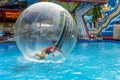 Odessa, Ukraine - May 6, 2019. Little children in an inflatable balloon, having fun on the water. The ball in the water - Royalty Free Stock Photo