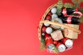 Odessa, Ukraine - November 10, 2021: Concept of gift with Christmas basket, red background