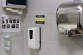 Odessa, Ukraine - November 7, 2021: Hand hygiene. Liquid soap dispenser, electric hand dryer, paper towel dispenser and hand