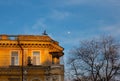 Odessa, Ukraine - 04 24 21: A part of yellow old building facade with windows, balcony and ancient statues. Architecture