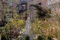 Odessa, Ukraine - 04 22 21: Spring in Old Odessa Square open-air museum. A statue of sorrowing maiden in front of tree