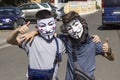 Odessa, Ukraine, summer 2021. Two teenage boys wearing Guy Fawkes masks