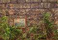 Odessa, Ukraine - 04 24 21: a wall with framed painting in a typical Odessa old town courtyard. Dirty scratched brick