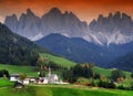 The church Santa Maddalena with the impressive Odle Mountains Group in the background at sunset. Royalty Free Stock Photo