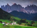 The church Santa Maddalena with the impressive Odle Mountains Group in the background at sunset. Royalty Free Stock Photo