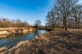 Odra river with grass, trees around and clear sky in CHKO Poodri in Czech republic