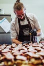 Odziena / Latvia - August 24th, 2018: Male Chef Putting Ingredients of Burgers in Black Gloves - Concept of the Hard Working