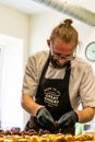 Odziena / Latvia - August 24th, 2018: Male Chef Putting Ingredients of Burgers in Black Gloves - Concept of the Hard Working