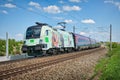 OEBB class electric locomotive pulling a Railjet over the railway tracks in Ostermuenchen, Germany