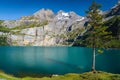 Oeschinensee alpine lake with beautiful high mountains and glaciers, Switzerland