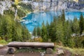 Oeschinnensee, wooden bench and Swiss Alps, Switzerland.