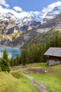 Oeschinnensee, wooden chalet and Swiss Alps, Switzerland.