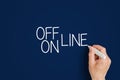 Off line and on line. a man writes on the wall with a marker - off line and on line. Royalty Free Stock Photo