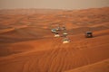 Off-road adventure with SUV driving in Arabian Desert at sunset. Offroad vehicle bashing through sand dunes in Dubai desert. Tradi