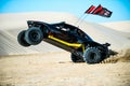 Off road buggy car in the sand dunes of the Qatari desert.