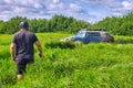 Off-road car of blue color splashing mud passes a dangerous obstacle. Royalty Free Stock Photo