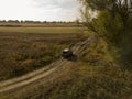 Off road car on the forest and field summer dirt road top view f Royalty Free Stock Photo