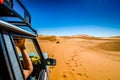 Off road car learning how to drive in sand dunes in Erg Chebbi, Morocco Royalty Free Stock Photo