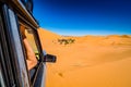 Off road car learning how to drive in sand dunes in Erg Chebbi, Morocco Royalty Free Stock Photo