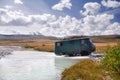 Off-road car moving mountain river at a ford on the background of snow peaks Royalty Free Stock Photo