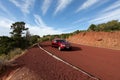 Off road car on red tarmac in high mountains Royalty Free Stock Photo