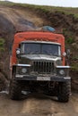 Off-road extreme expedition truck driving on mountain road, transportation travelers