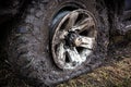 Offroad flat tyre and rim in mud close up Royalty Free Stock Photo